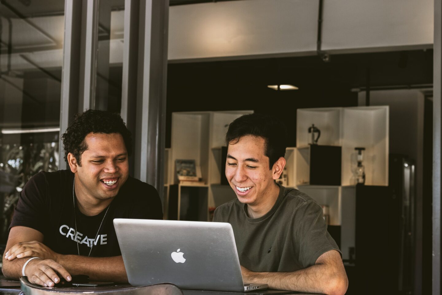 Two people looking at a laptop screen