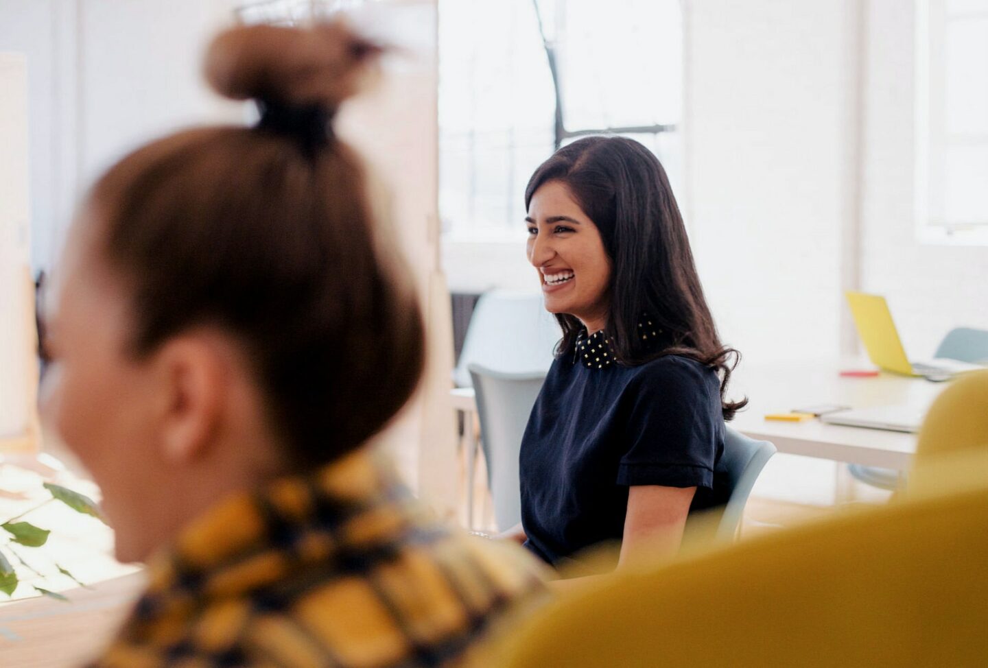 Woman smiling at someone around a table