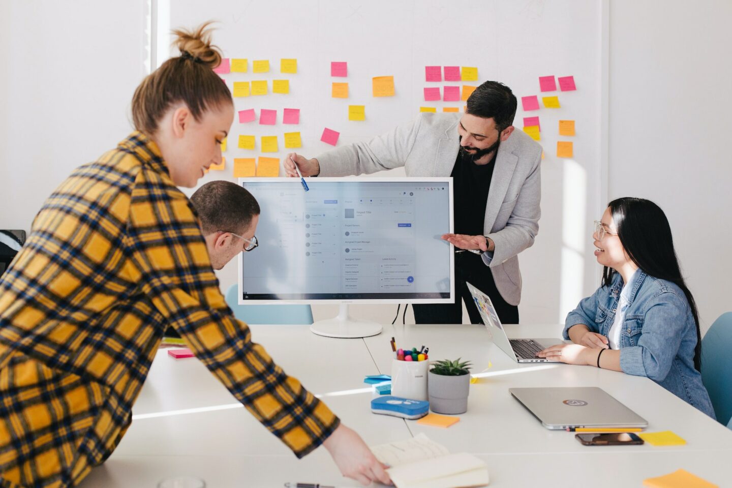 People in a meeting looking at a computer screen