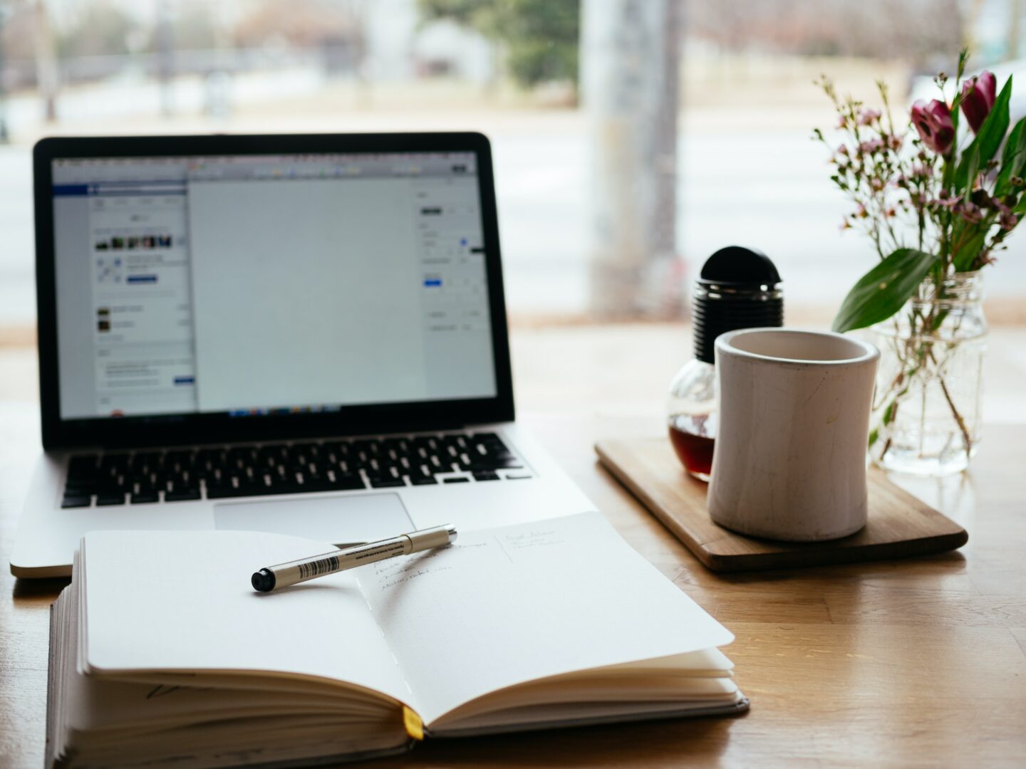 Photo of a notebook in front of a laptop screen