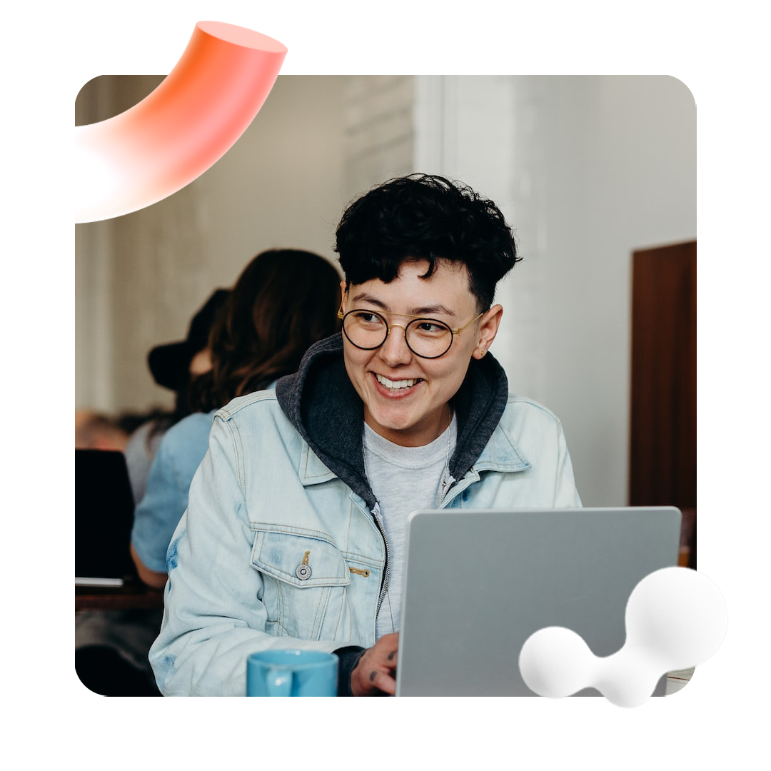 Person smiling in front of a laptop