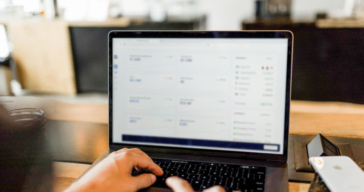 Individual sat at a laptop performing data analysis